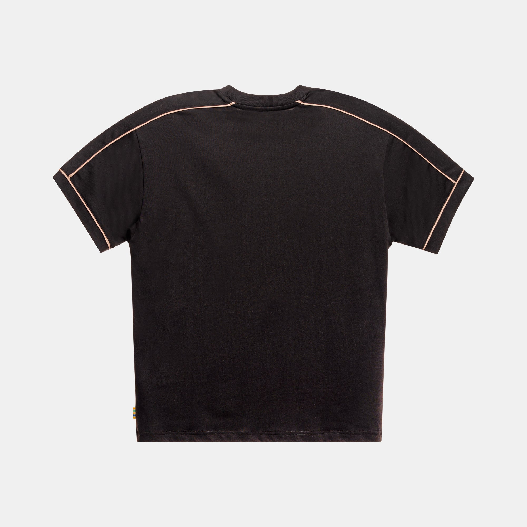 Back side of a black oversize tee featuring gold piping along sleeve seams. The bottom left has a striped woven folder over tab.