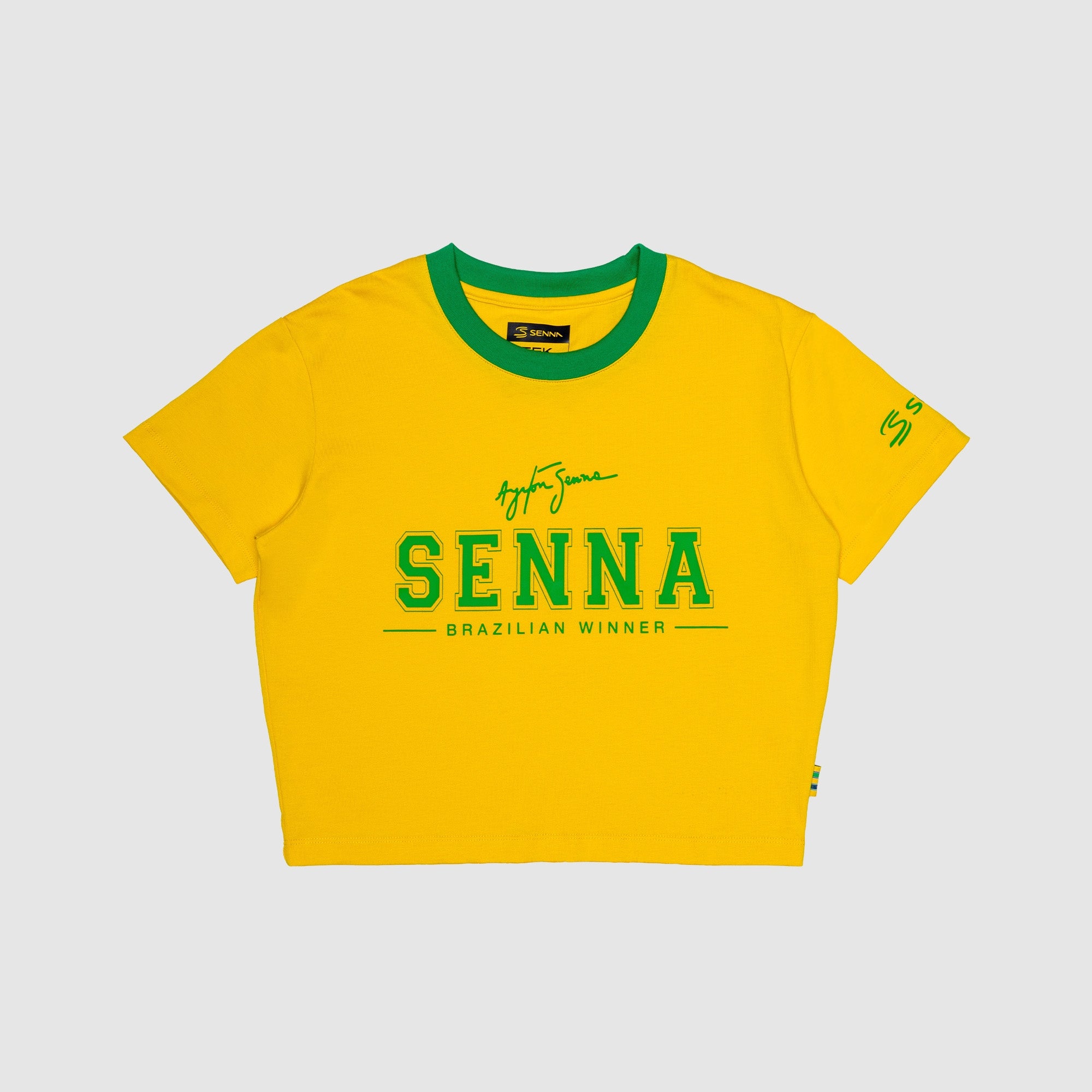 Yellow crop top with green accents and 'Senna' branding on a light gray background