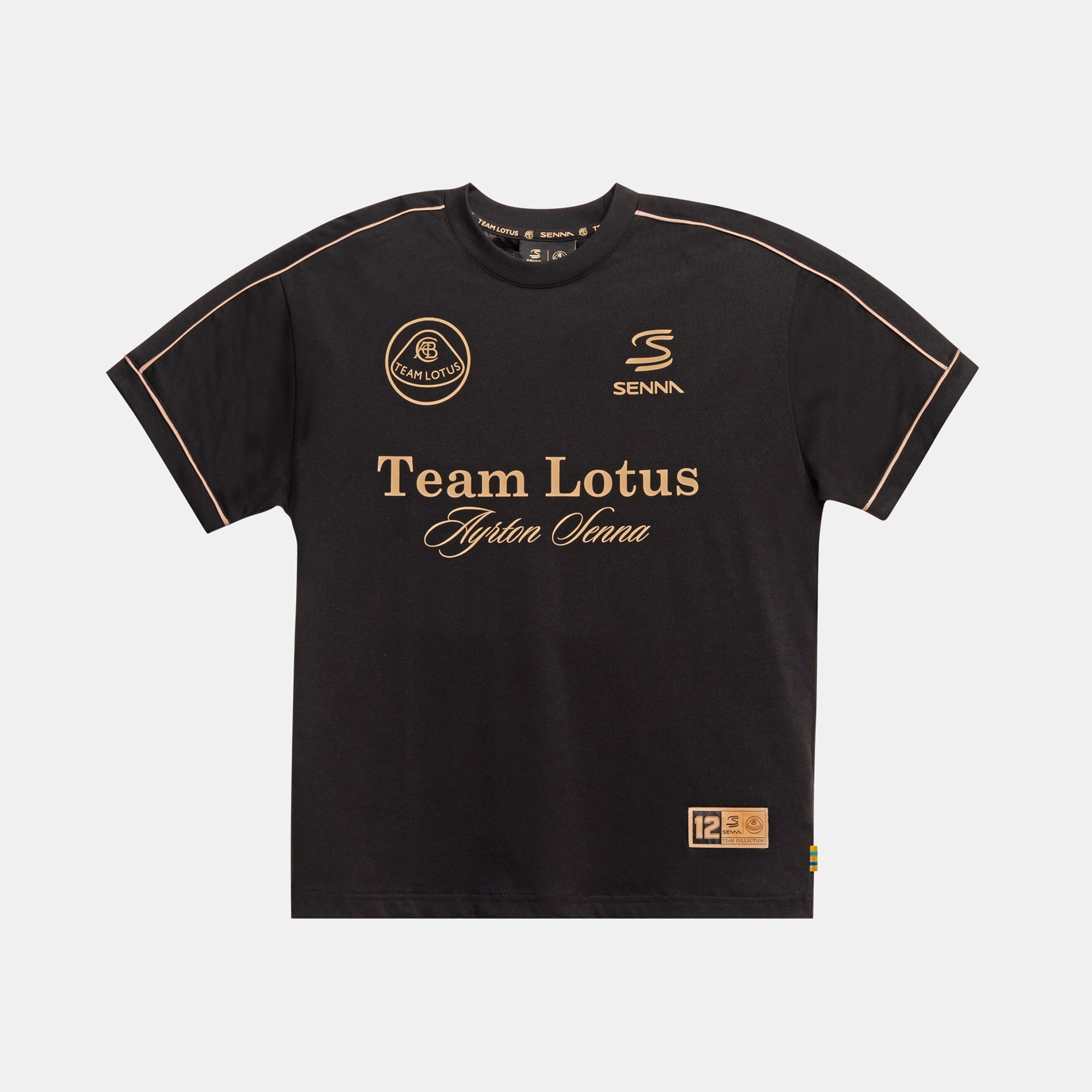 A black oversize short-sleev t-shirt with gold piping along seams. The front features 'Team Lotus' and 'Ayrton Senna' in gold lettering, along with the Senna logo and a circular Team Lotus crest.